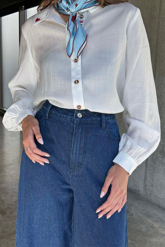 Blue Denim Pallazzo Jan Jean in a wide-leg style, styled with a white shirt and a patterned neck scarf.