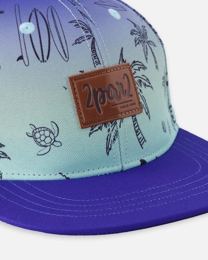 Deux par Deux boys' blue beach print flat-brim cap – close-up of the logo patch and print