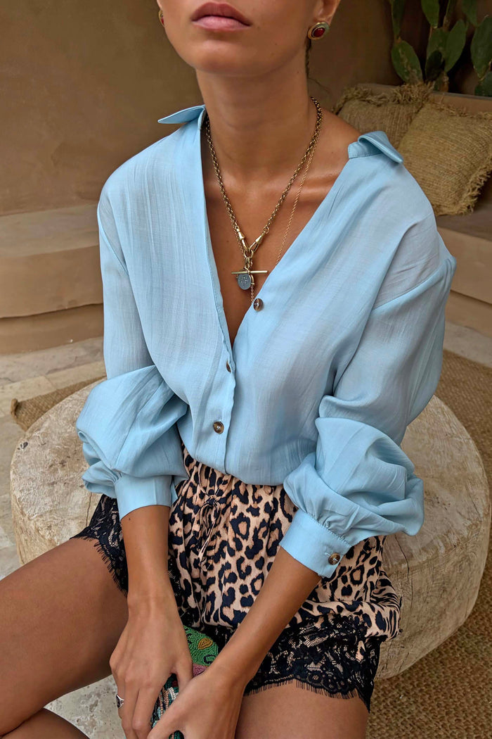 Ice Blue Miley Shirt with blouson sleeves and tortoise buttons, styled with leopard print lace shorts.