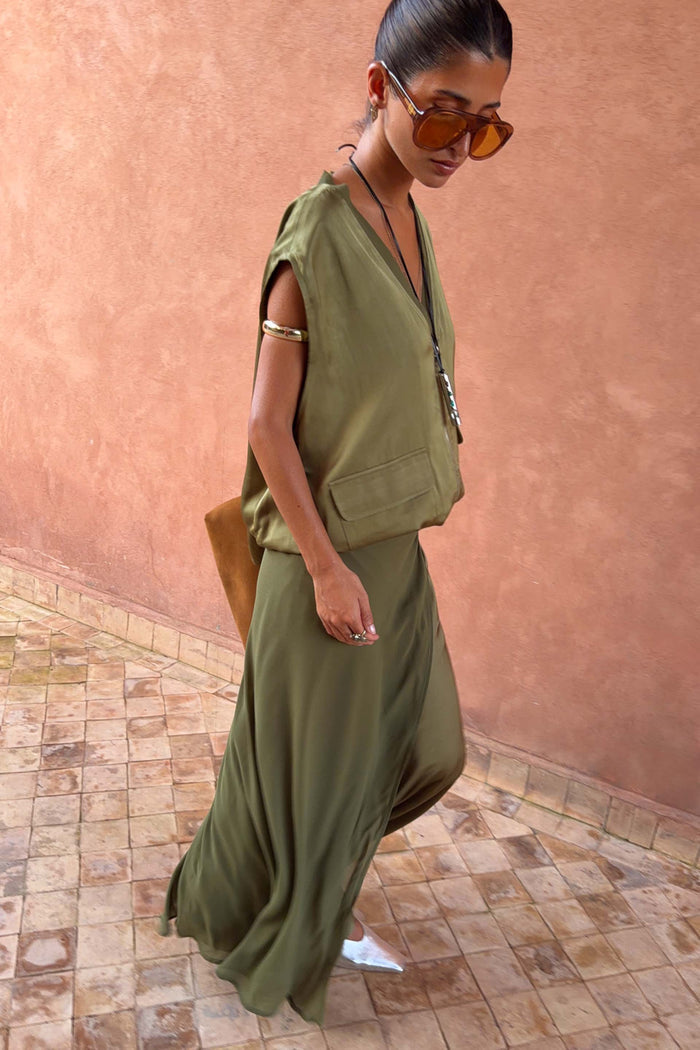 Olive Wrap Jojo Midi Skirt with contrasting matte and satin panels, paired with a matching utility vest.