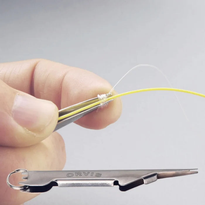 Orvis stainless steel nail knot tying tool demonstrating a completed nail knot with yellow fishing line