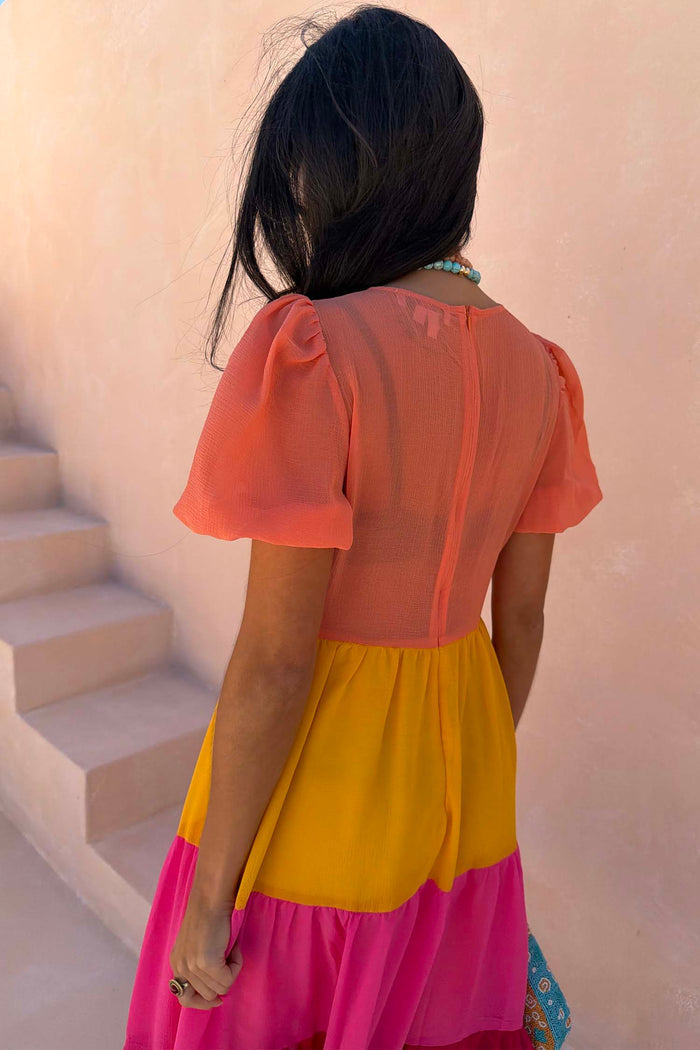 Tiered Orange and Pink Abigail Dress with a sheer top, puffed sleeves and back zip fastening.