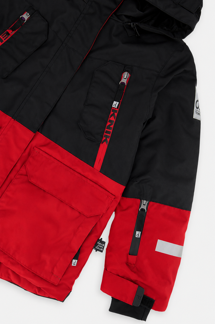Close-up of the red and black TEKNIK jacket chest pocket, sleeve zip pocket and logo patch