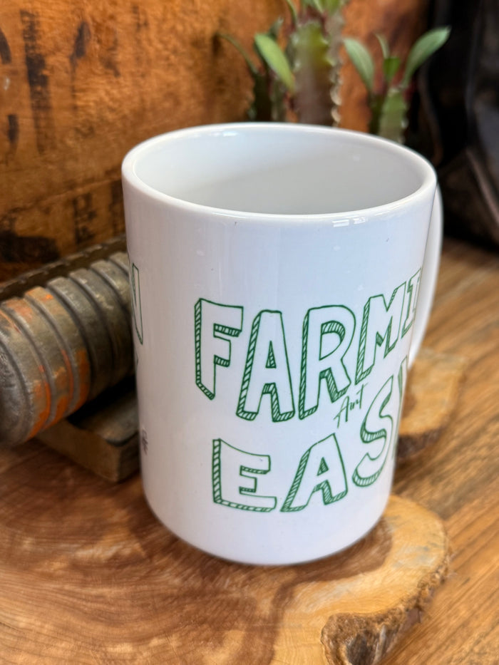 White ceramic mug showing green 'EASY' text on front with handle