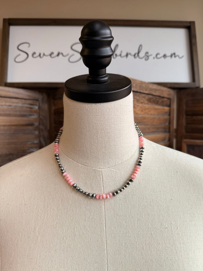 Pink mother-of-pearl sterling bead necklace with silver-tone and pink beads on mannequin