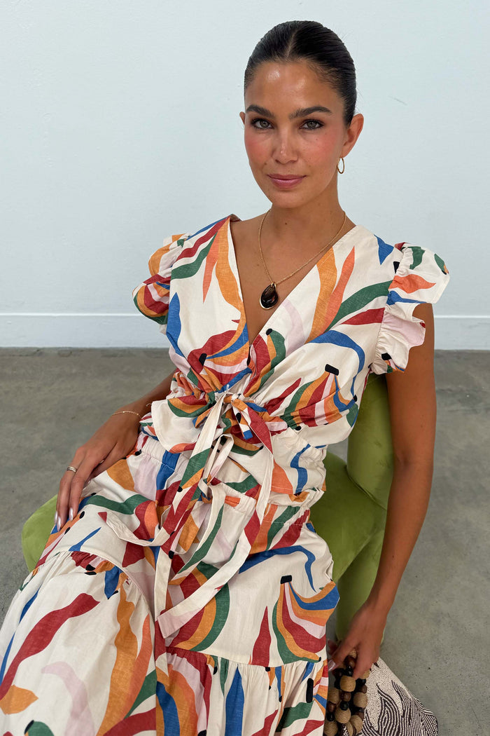 Banana Kerri Top in a colourful banana print with a tie front and puff sleeves, paired with the matching skirt.