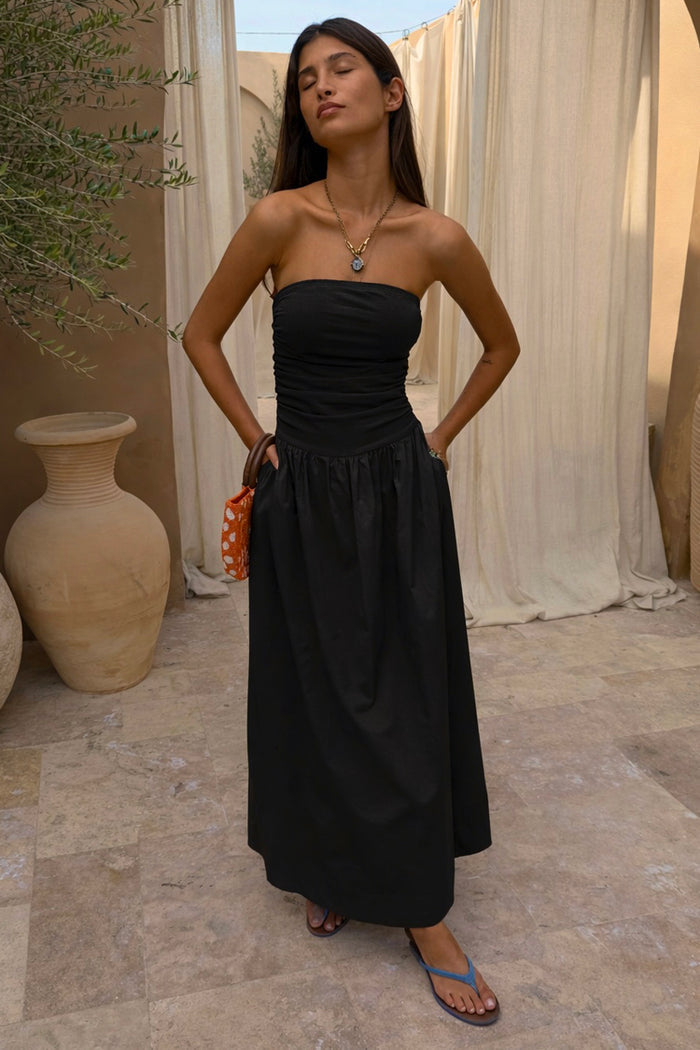 Strapless Black Lola Mid-axi Dress in breathable cotton featuring a ruched bodice and full flowing skirt.