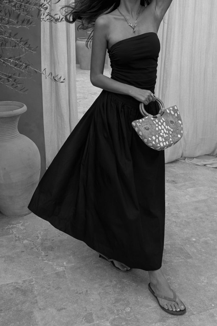 Black Lola Mid-axi Dress featuring a ruched bandeau top and full cotton skirt.