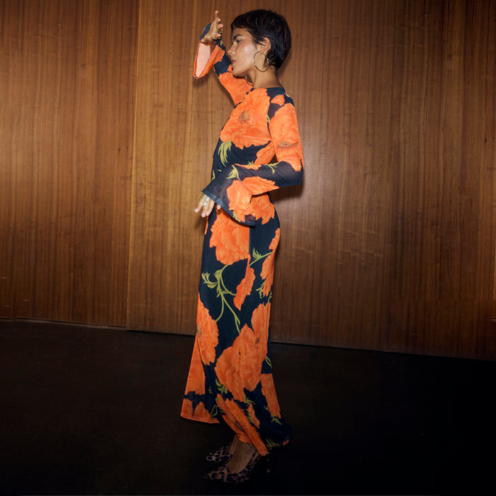Black Poppy Aria Mesh Dress in sheer fabric with a vibrant floral print, flared sleeves and a midaxi length.