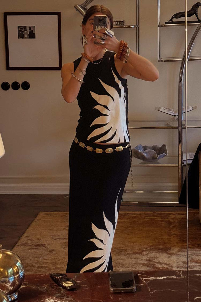 Black Sol Tank Top with a hand painted sun print, styled with a matching skirt and gold belt in a mirror selfie.