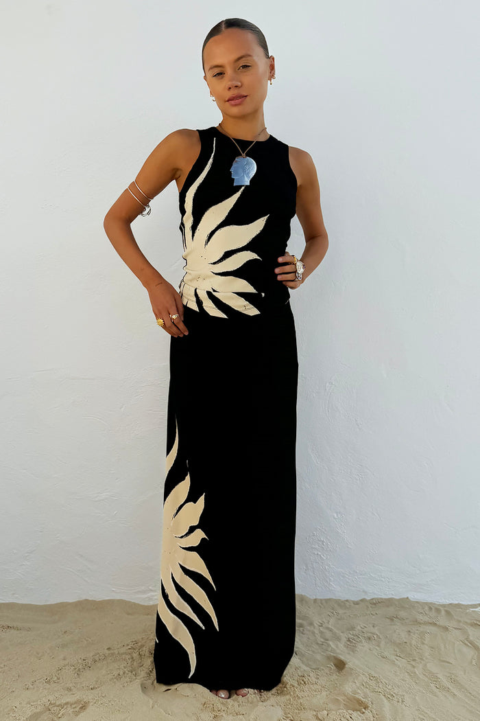 Black Sol Tank Top with an in-house designed cream sun motif, paired with a matching maxi skirt for a beach holiday look.