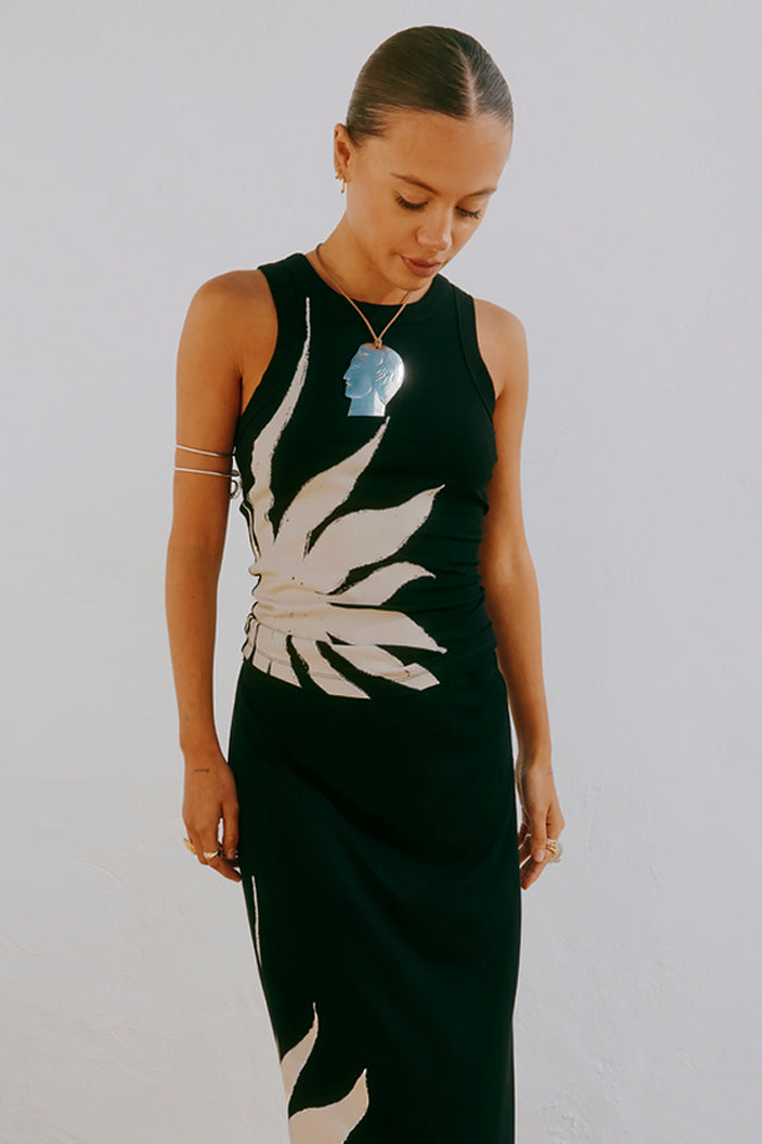 Black Sol Tank Top featuring a hand-painted sun print, styled with a matching skirt and silver jewellery.