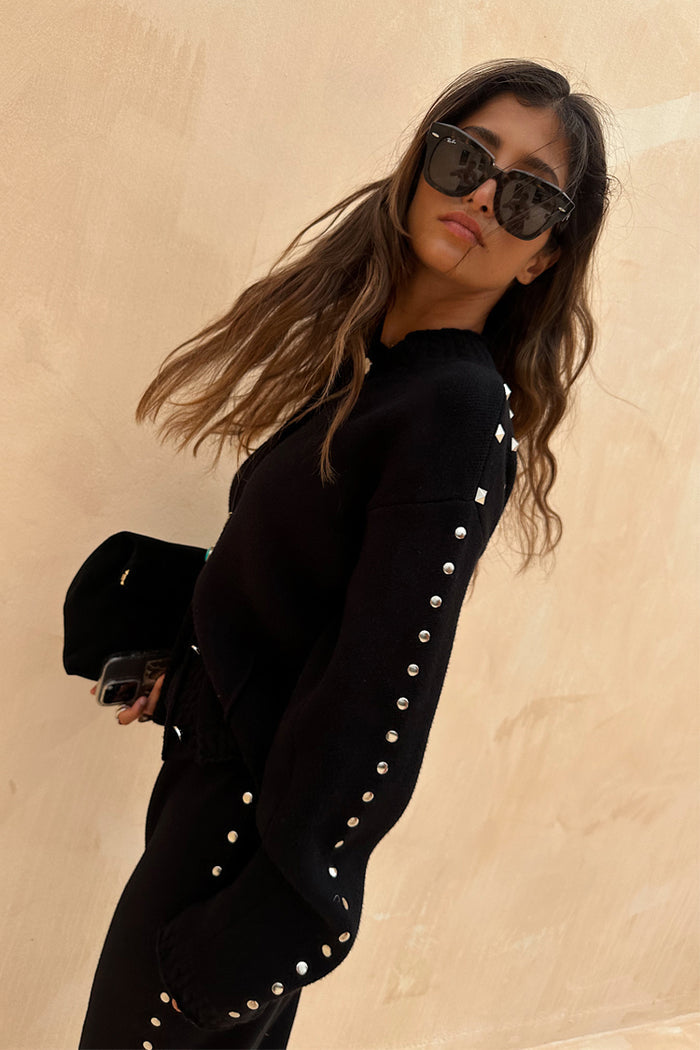 Black Studded Cardigan featuring silver metal studs on the sleeves and a structured fit, a versatile statement staple.