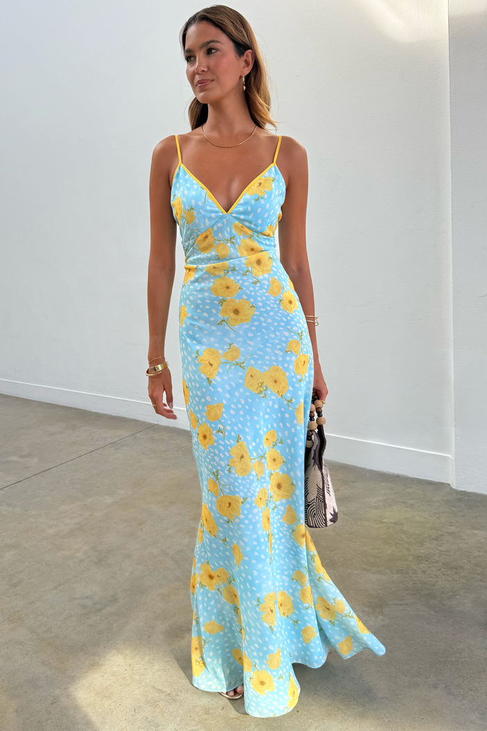 Blue Fawn Poppy Elsie Dress with yellow poppy prints and white fawn spots in a bias-cut slip style on a model.