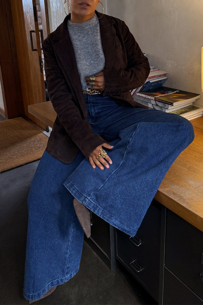 Blue Denim Pallazzo Jan Jean with a wide-leg silhouette, styled with a brown blazer and leopard print belt.