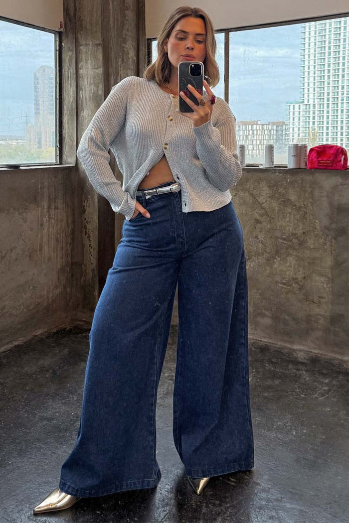 Blue Denim Pallazzo Jan Jean with a voluminous wide-leg fit, styled with a silver cardigan for an effortless London look.