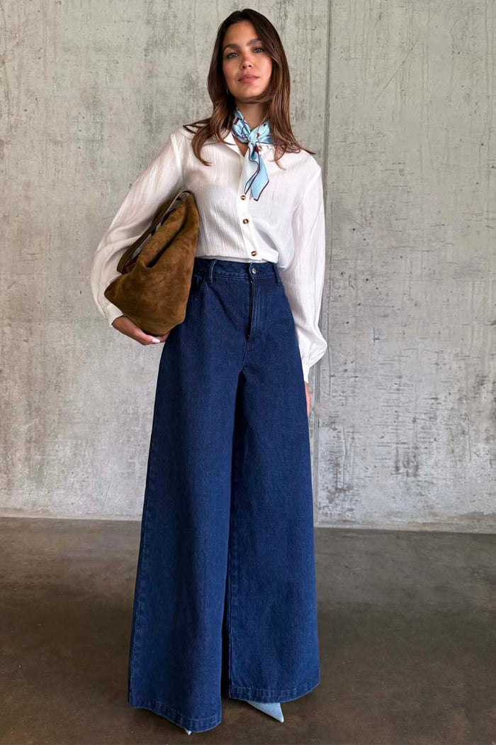 Blue Denim Pallazzo Jan Jean with a wide-leg style and high-waisted fit, paired with a white shirt.