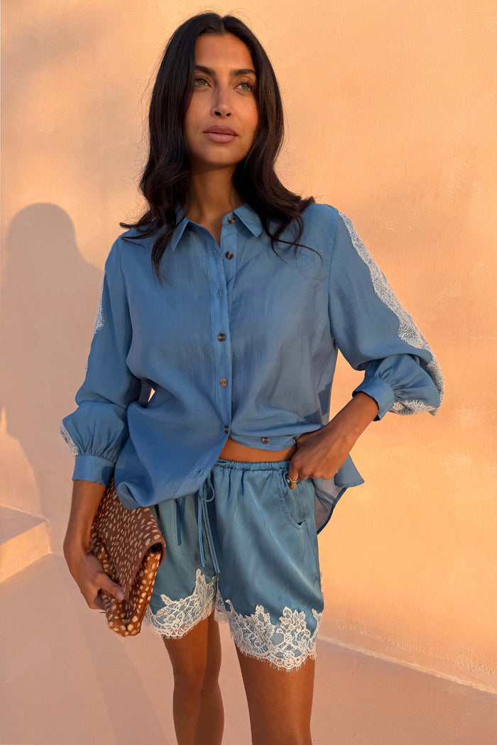 Washed blue satin Maeva Shorts with white lace trim, styled as a co-ord with a matching shirt.