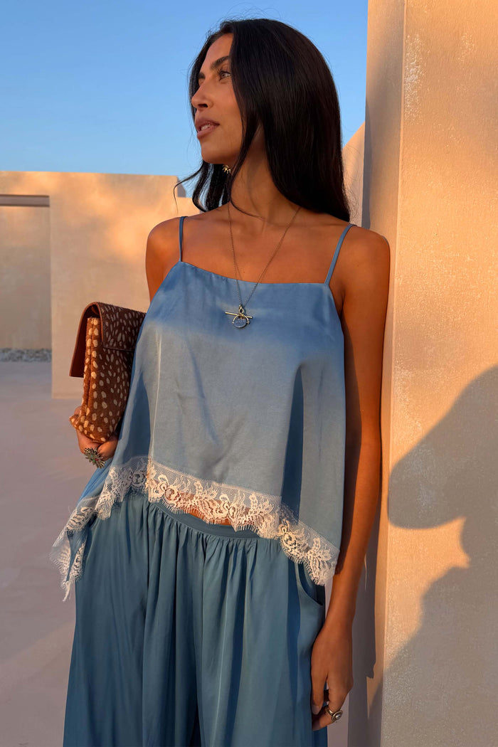Blue Lace Swing Cami featuring a satin-esque base, fine straps and a white lace-trimmed hem on a model.