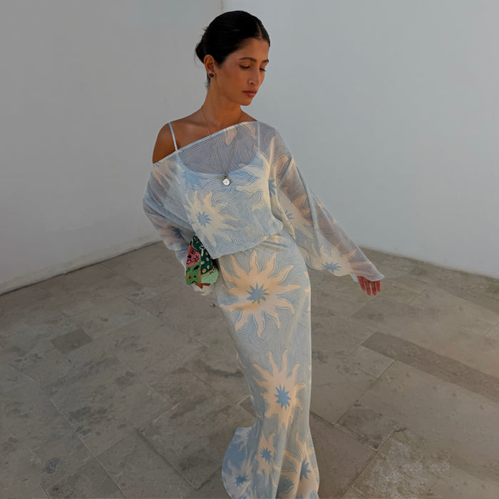 Blue Soleil Anais Dress featuring a Mediterranean soleil sun print, sheer draped top and satin-esque maxi skirt.
