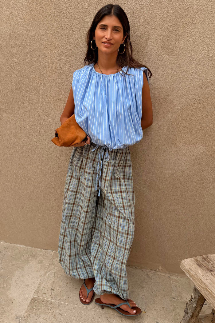 Blue Stripe Bubble Top with a sleeveless bubble silhouette and elasticated hem, paired with wide-leg check trousers.