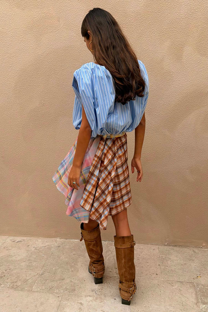Blue Stripe Bubble Top with a soft bubble silhouette and elasticated hem, styled with a multi-check skirt and boots.