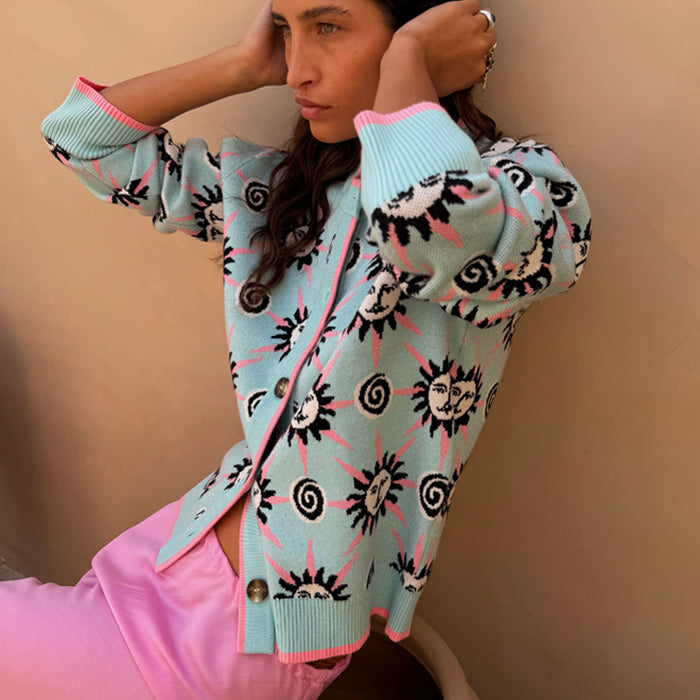Blue Sun Hollie Cardigan in baby blue knit with pink sun motifs, contrast trim and button front, worn by a model.