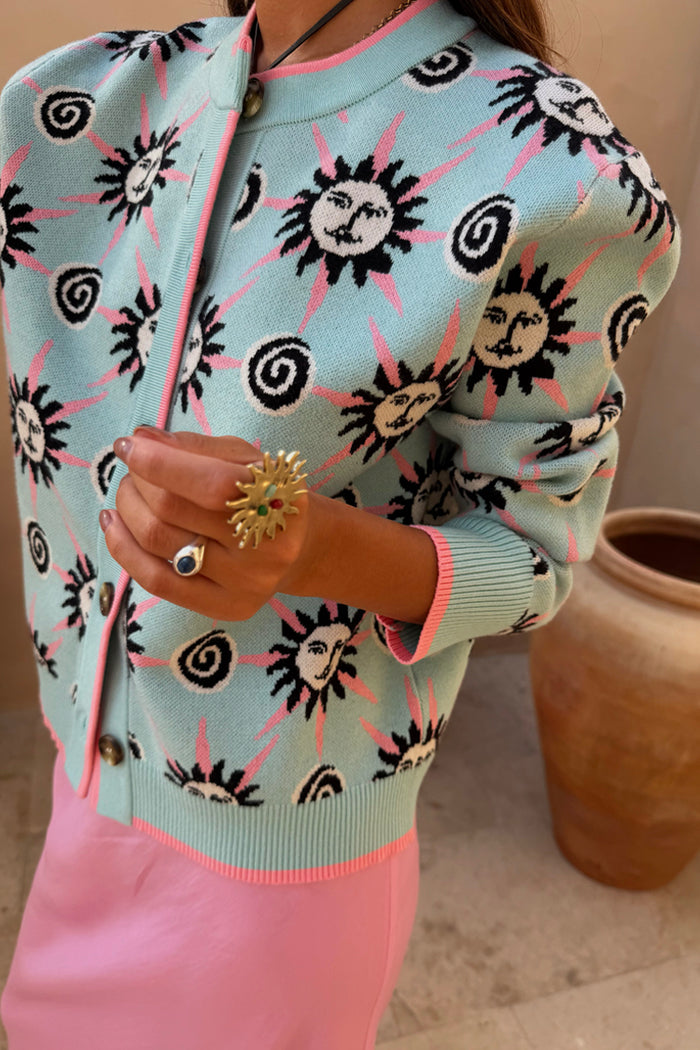 Blue Sun Hollie Cardigan in baby blue soft touch knit with pink trims and a sun and spiral print.