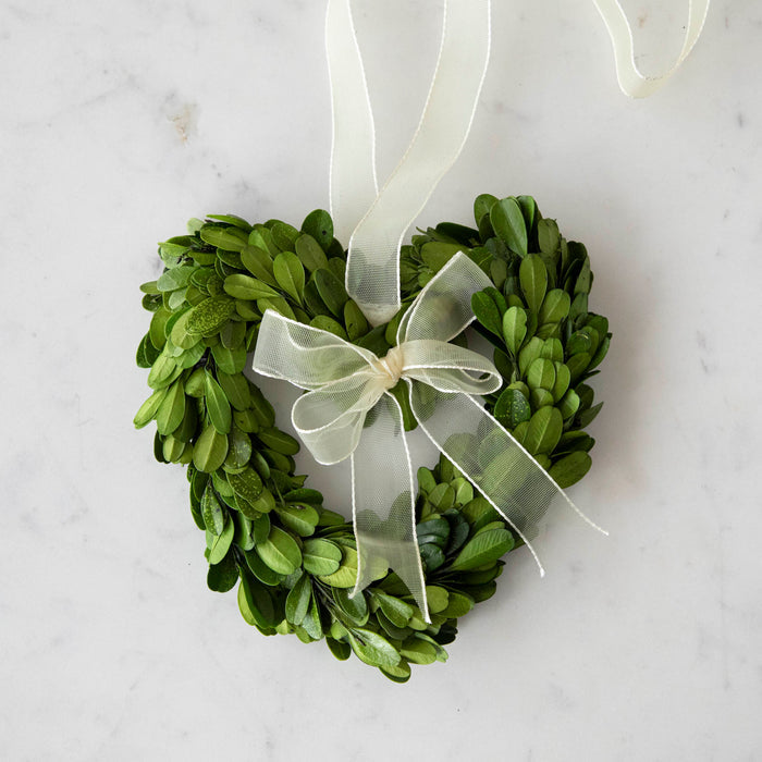 Three heart-shaped preserved Boxwood Wreath Hearts with Ribbons by Mills Floral Company on a white background.