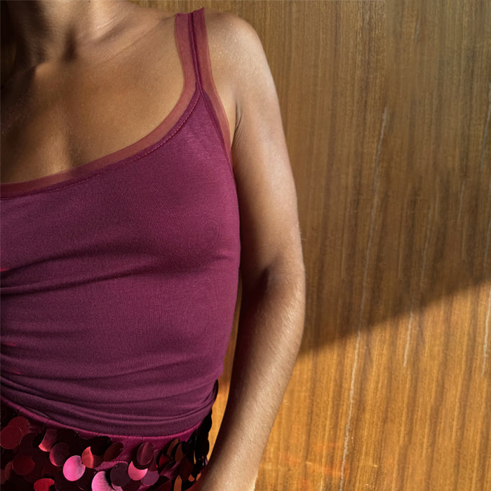 Burgundy Teddy Vest featuring mesh trim along the neckline and straps, styled with sequin bottoms.