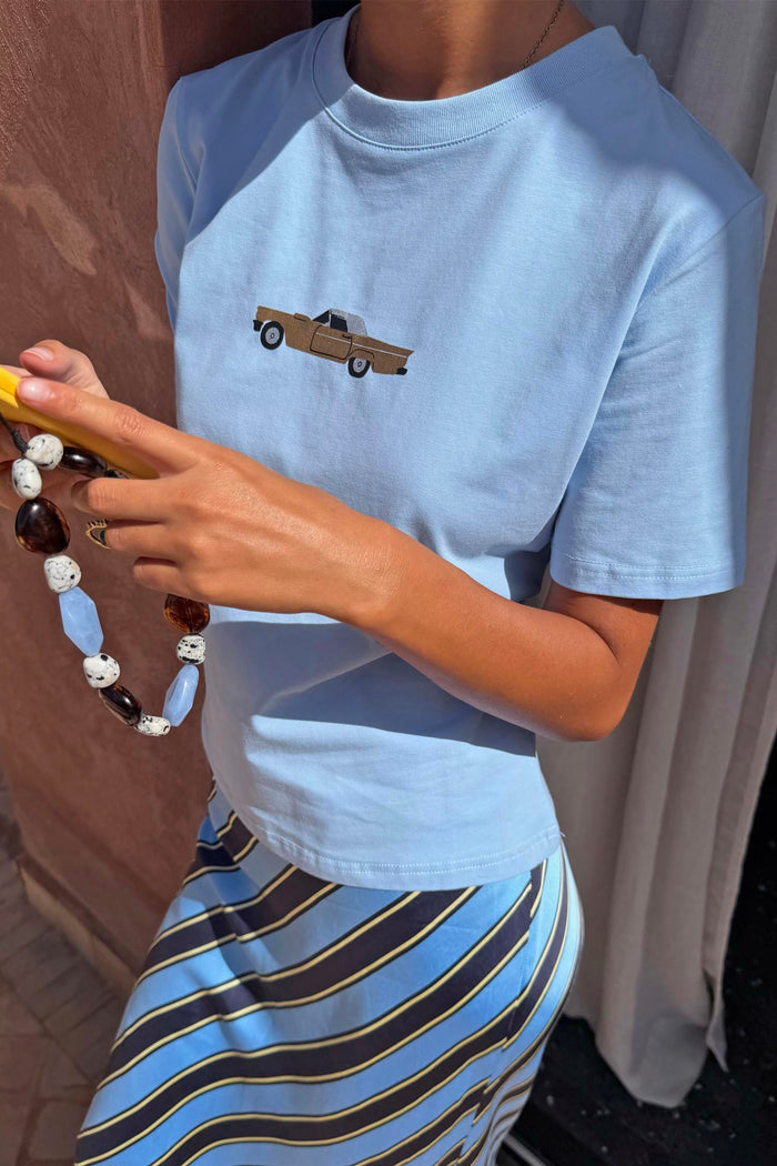 Blue cotton Cadillac Baby T-Shirt with a retro car motif, styled with a blue striped slip skirt.