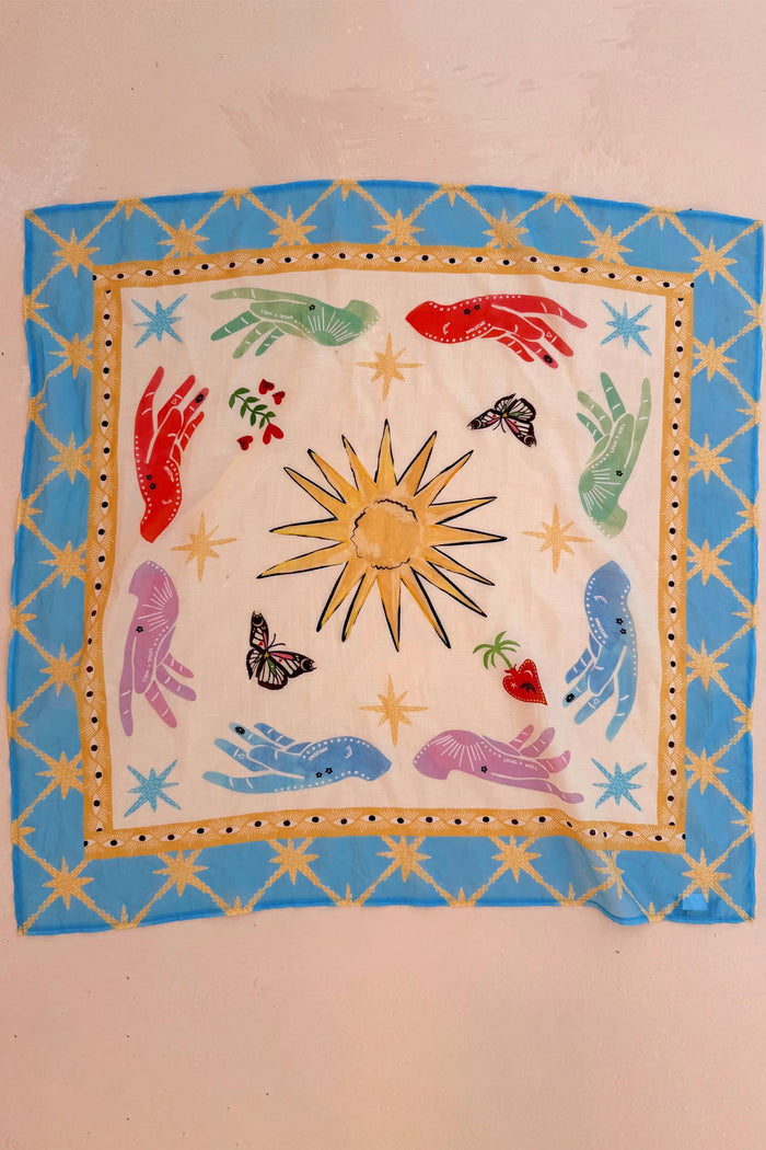 Celestial Bandana featuring hand-painted sun, mystical hands and eye motifs within a bold blue star border.