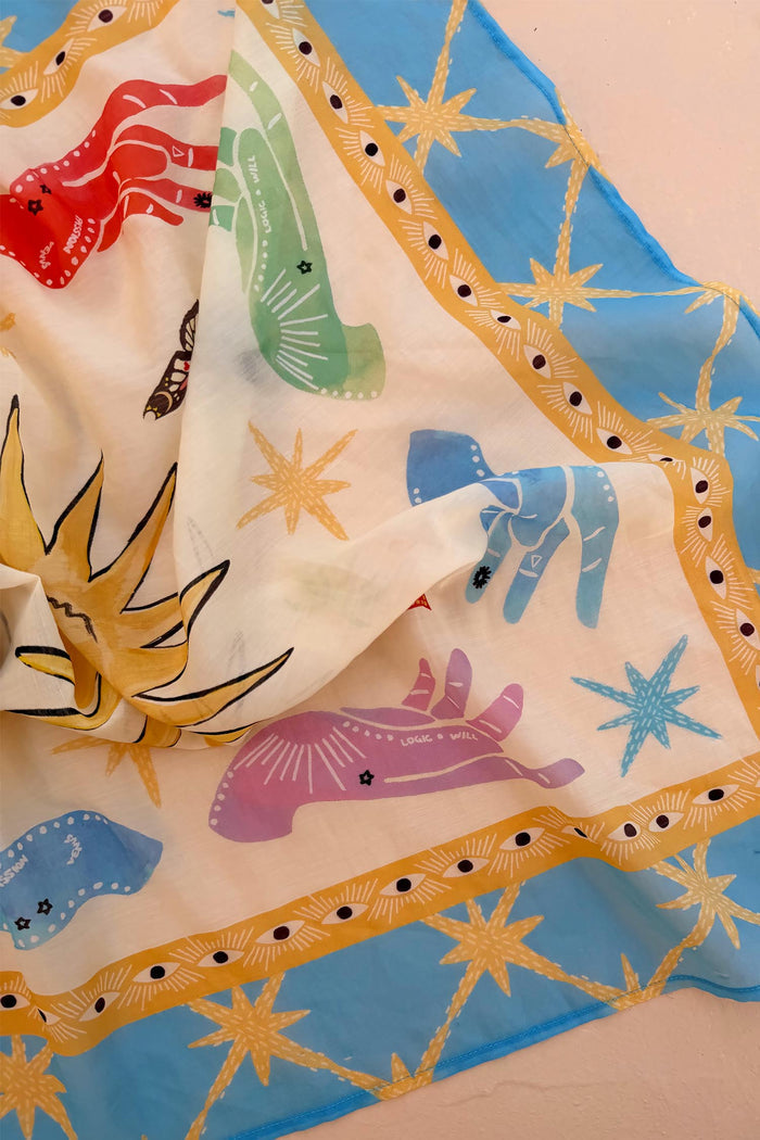 Celestial Bandana featuring hand-painted mystical hands and suns with a bold blue and yellow patterned border.