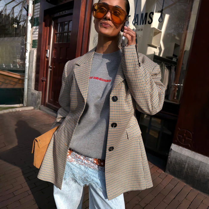 Grey tailored Check Blazer with button detailing and side pockets, styled with a grey top for a transeasonal London look.