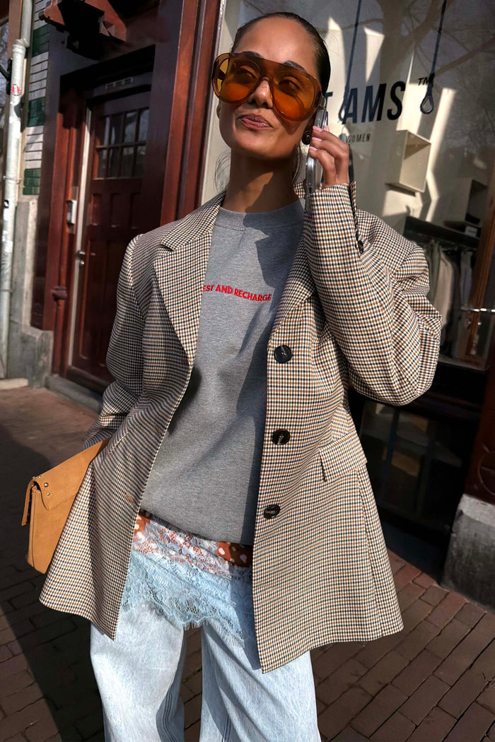 Tailored Grey Check Blazer layered with a slogan sweatshirt and lace-trim denim for a London street style look.