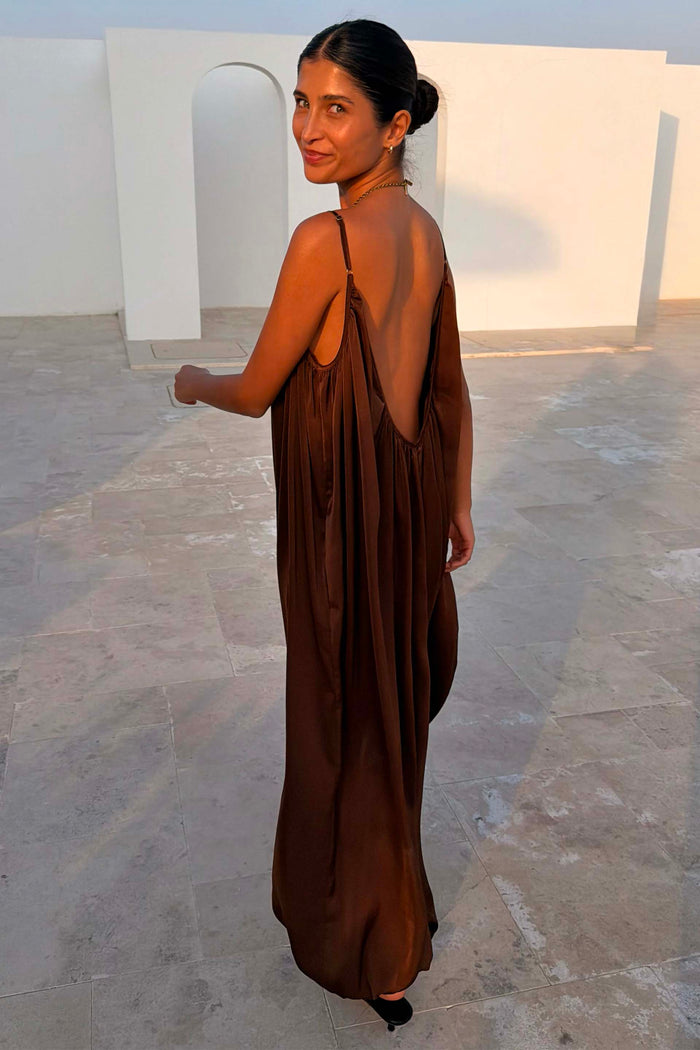 Chocolate Balloon Jumpsuit featuring a deep V back, draped silhouette and slim adjustable straps.