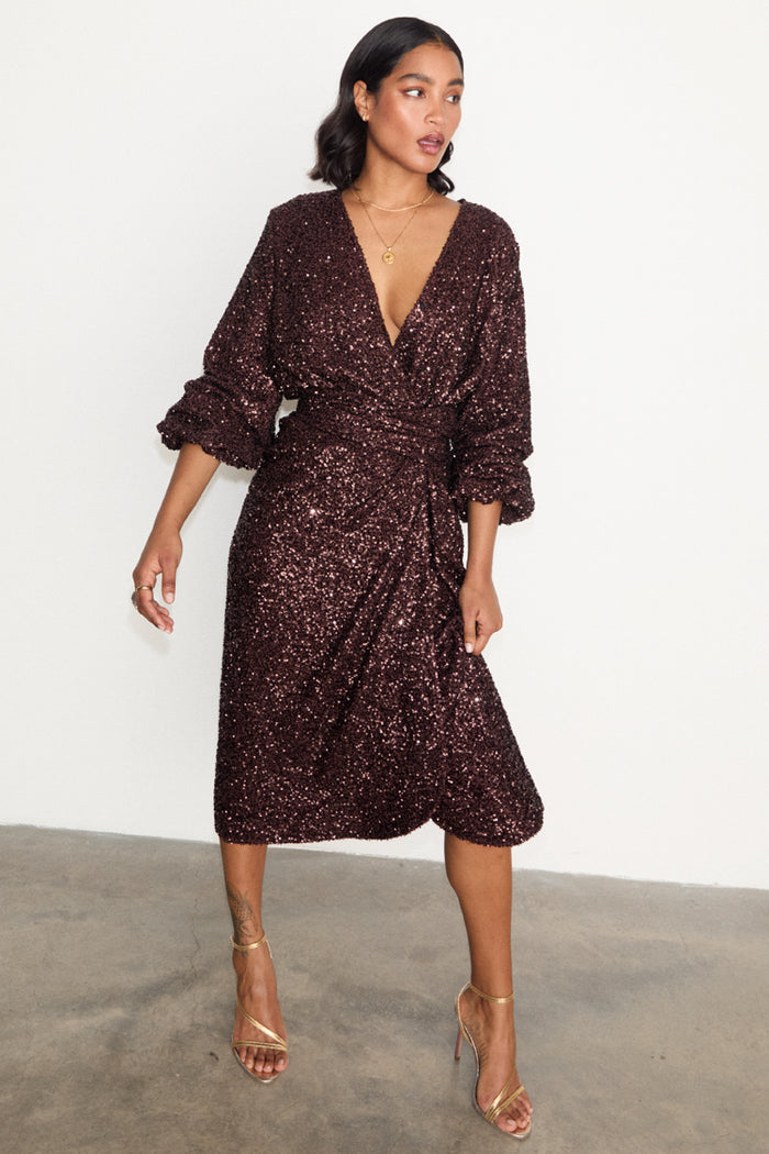 Chocolate Sequin Vienna Dress featuring a multi-wear wrap waist and puffed sleeves in a midi length.
