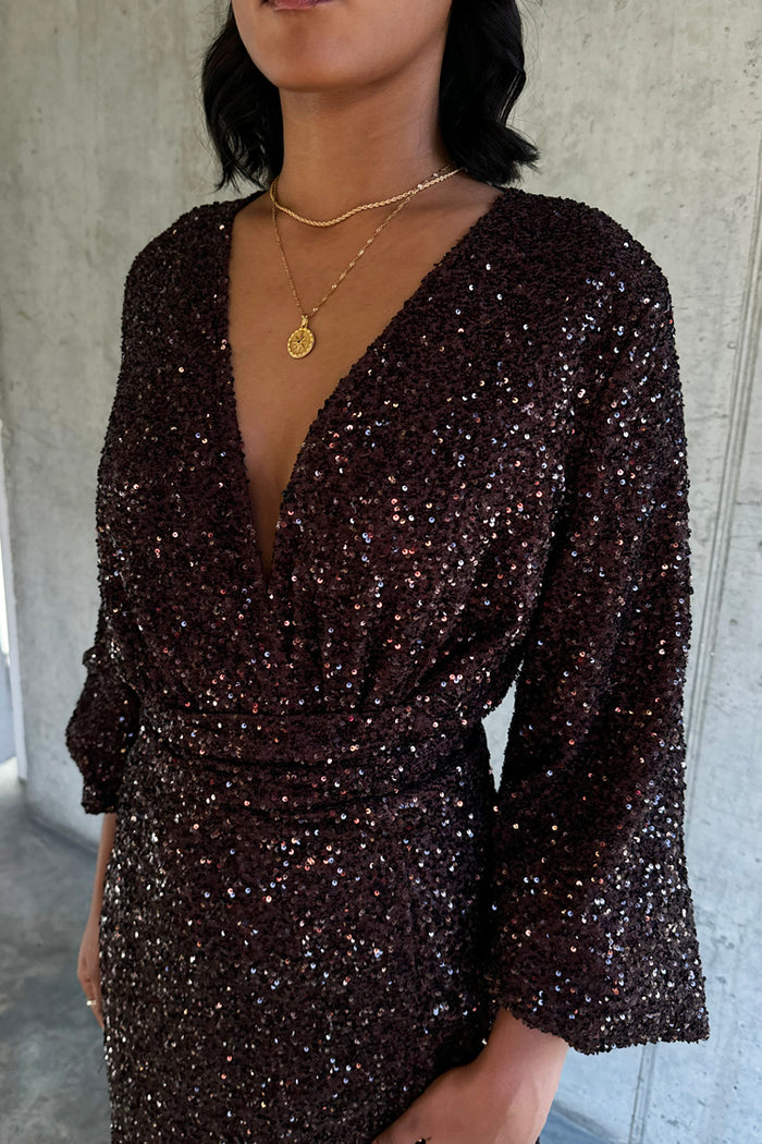 Chocolate Sequin Vienna Dress with a deep V-neckline and wrap waist, covered in shimmering brown sequins.