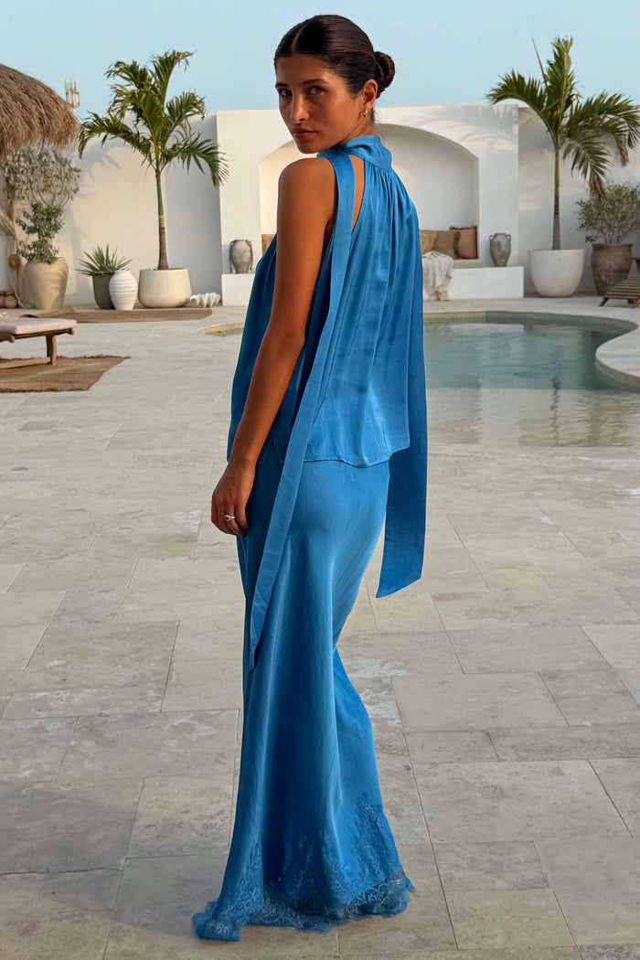 Cobalt Maeva Midi Skirt with a lace hem and matching top, styled as a co-ord in a poolside vacation setting.