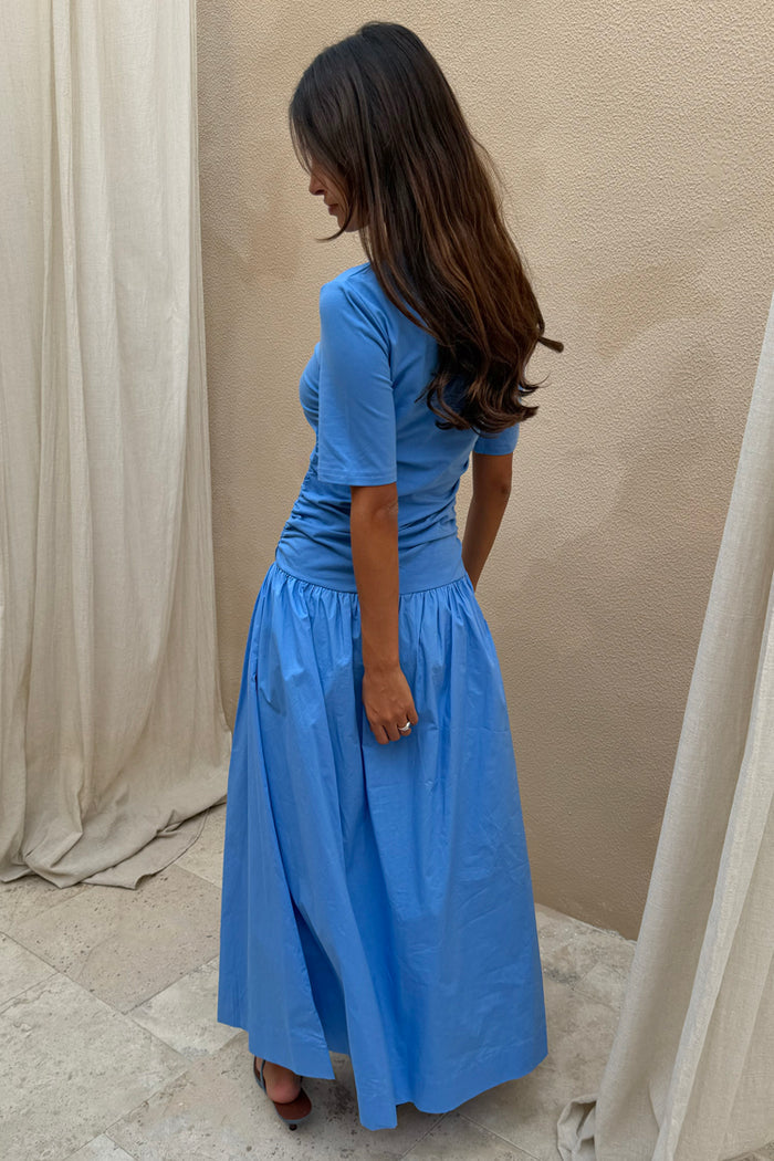 Cornflower Blue Grace Dress featuring a ruched waist and cotton A-line skirt, shown from a side profile.