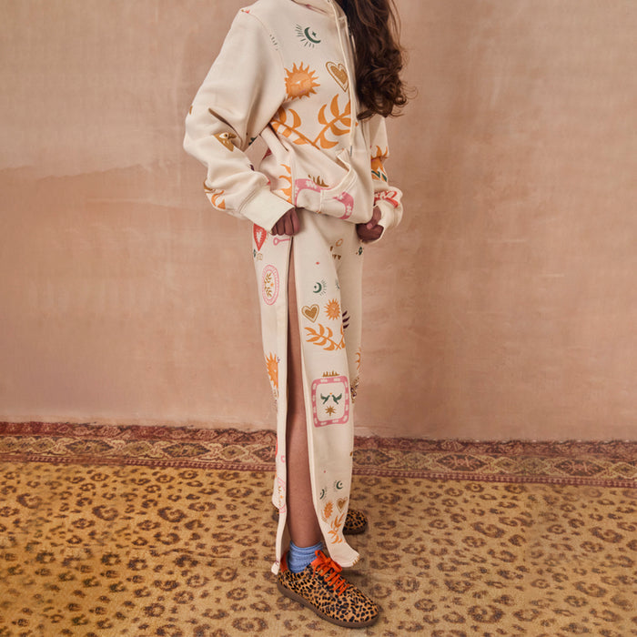 Cream Sundazed Wide Leg Accessible Joggers with iconic sun motifs and side zips for treatment accessibility.