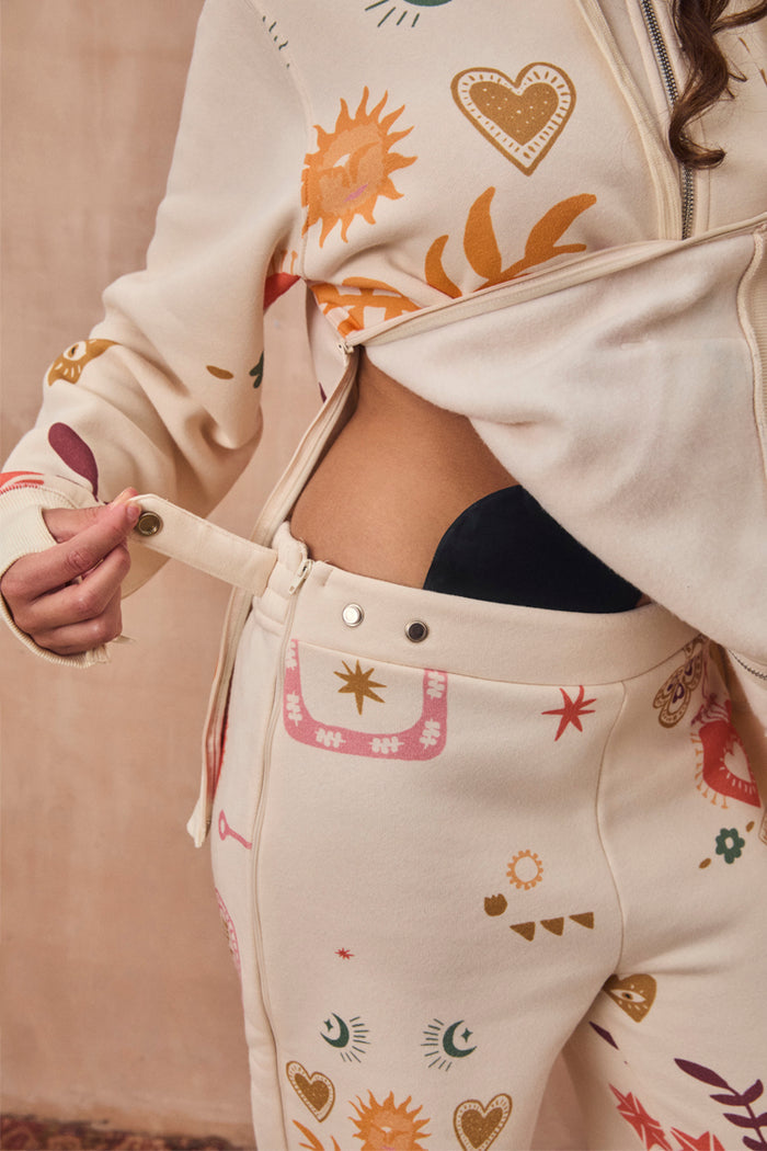 Cream Sundazed Accessible Joggers featuring side zips and poppers for treatment access and iconic prints.