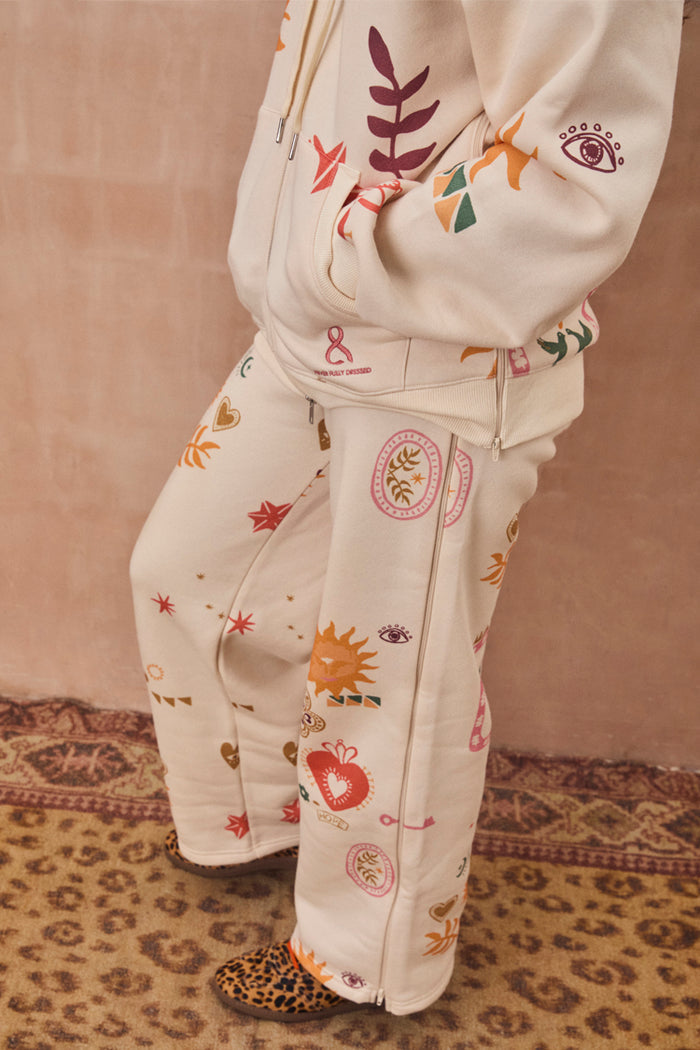 Cream Sundazed Wide Leg Accessible Joggers with iconic NFD prints and side zips for treatment access.