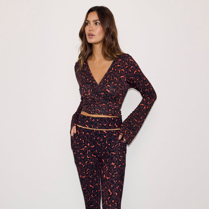 Dark Leopard Ballet Wrap top with orange accents and flared sleeves, paired with matching leopard print leggings.