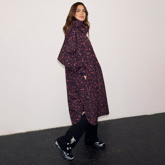 Dark Leopard Rain Mac in a relaxed fit with an iconic animal print, waterproof material, and side pockets.
