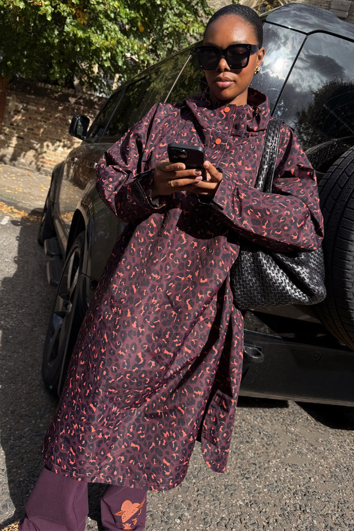 Dark Leopard Rain Mac in a relaxed waterproof fit, featuring an iconic animal print and styled for a London look.