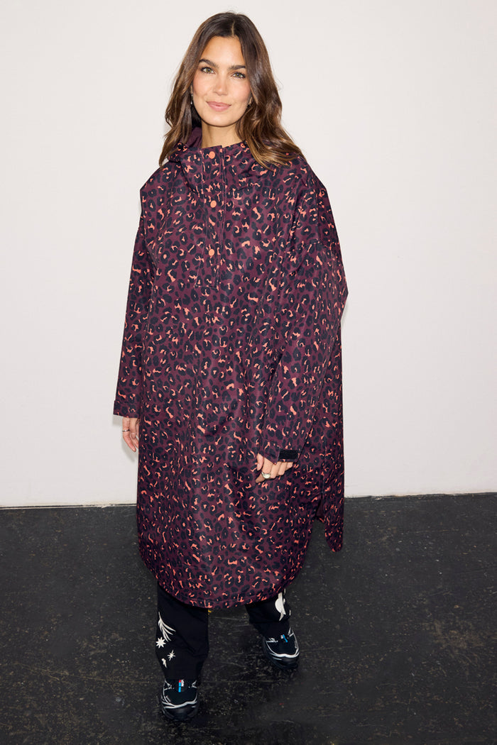 Dark Leopard Rain Mac with a relaxed fit, waterproof fabric, and front button detailing on a model.