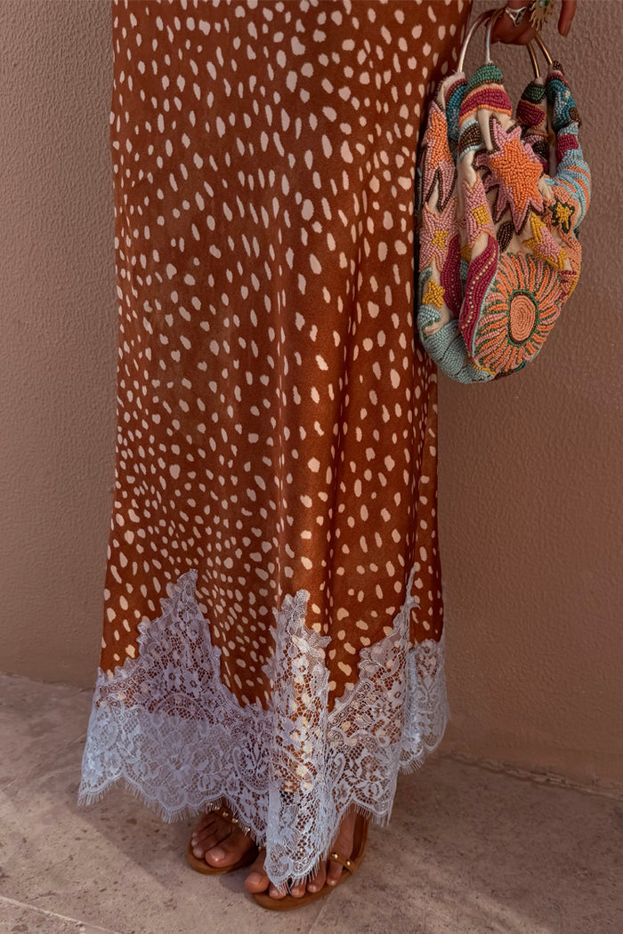 Fawn Midi Maeva Skirt featuring a brown fawn print and delicate lace trim, styled with a colourful beaded bag.