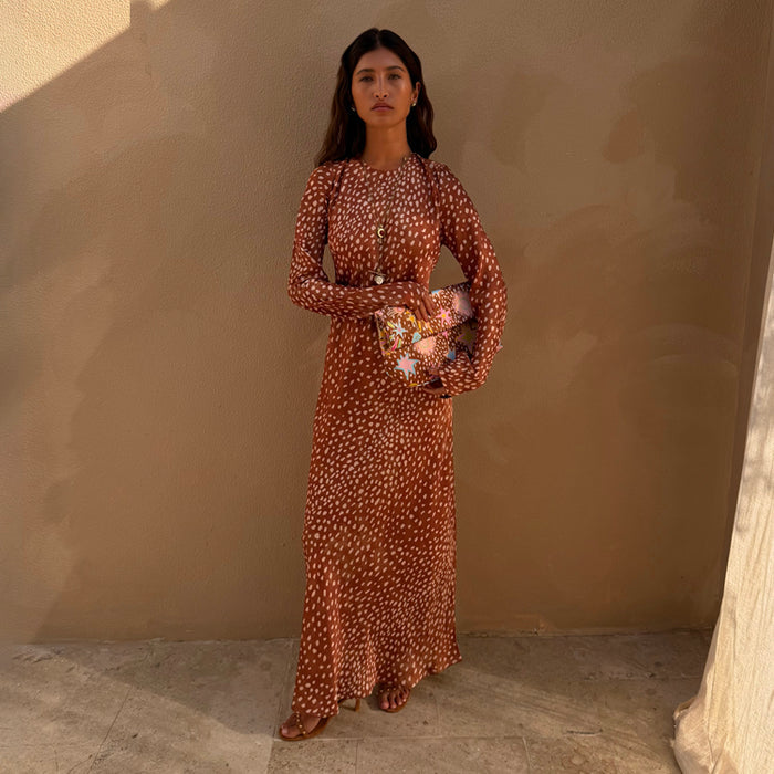 Fawn Soho Dress in a brown and cream spotted fawn print with long flared sleeves and a maxi silhouette.