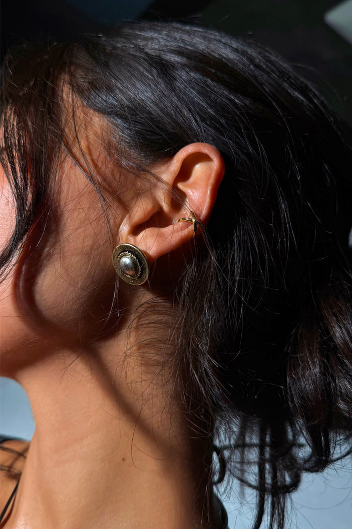 Deloris Silver Circle Earrings featuring textured brushed metal and vintage vibes, worn by a model.